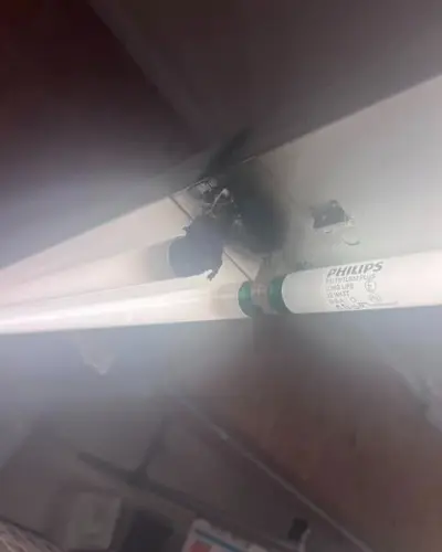 A melted T8 lamp socket in a store light fixture